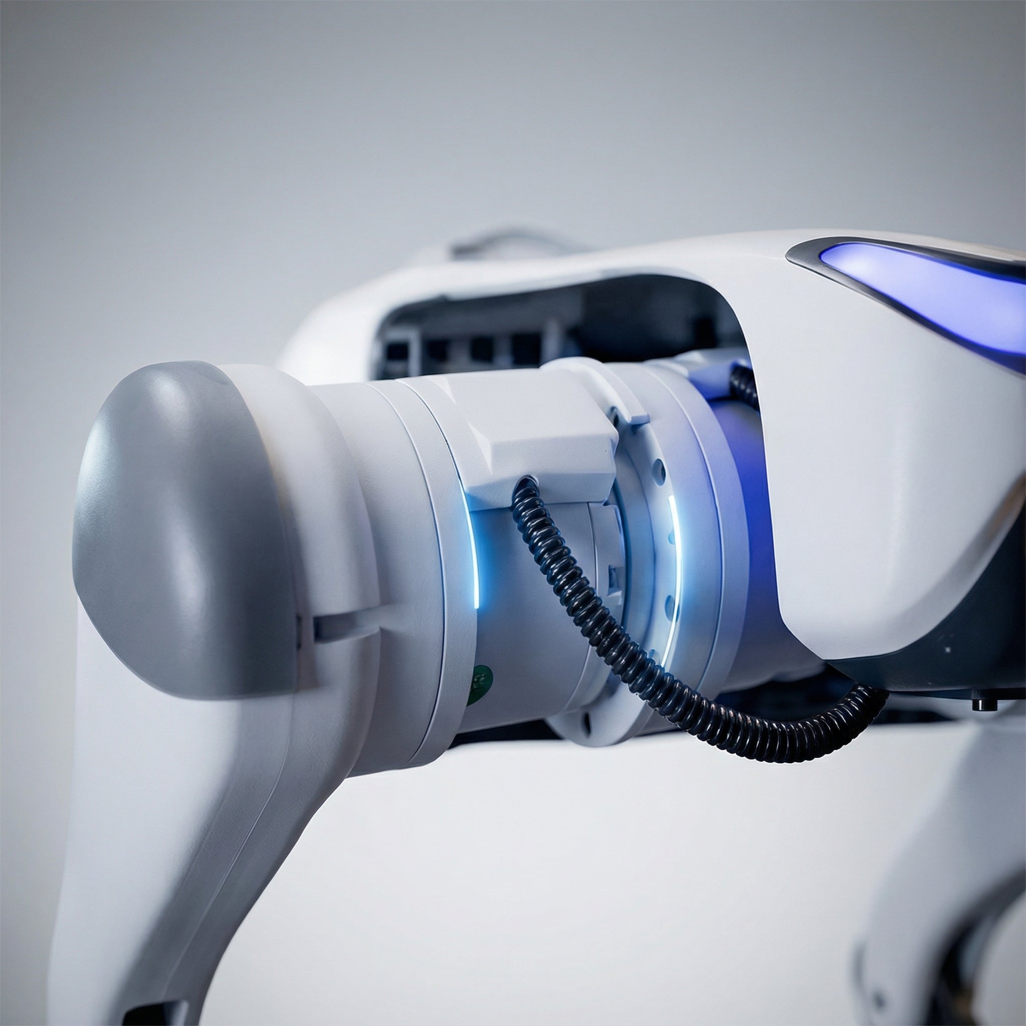 A close-up view of the DEEP Robotics Lite3 quadruped robot's leg, highlighting its advanced actuator with a bright blue glowing ring, symbolizing enhanced torque and exceptional power. This detail underscores the robot's capability for stable, precise motion control and agile performance in demanding applications such as robotics research, education, and industrial inspections.