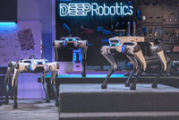 Three DEEP Robotics Lite3 quadruped robots in a modern lab setting, showcasing their advanced design for research, education, and industrial applications. These agile robot dogs feature AI-driven mobility, real-time control, and modular capabilities, supporting functions like autonomous navigation, obstacle avoidance with LiDAR and depth cameras, and ROS-based development for complex tasks and reinforcement learning.