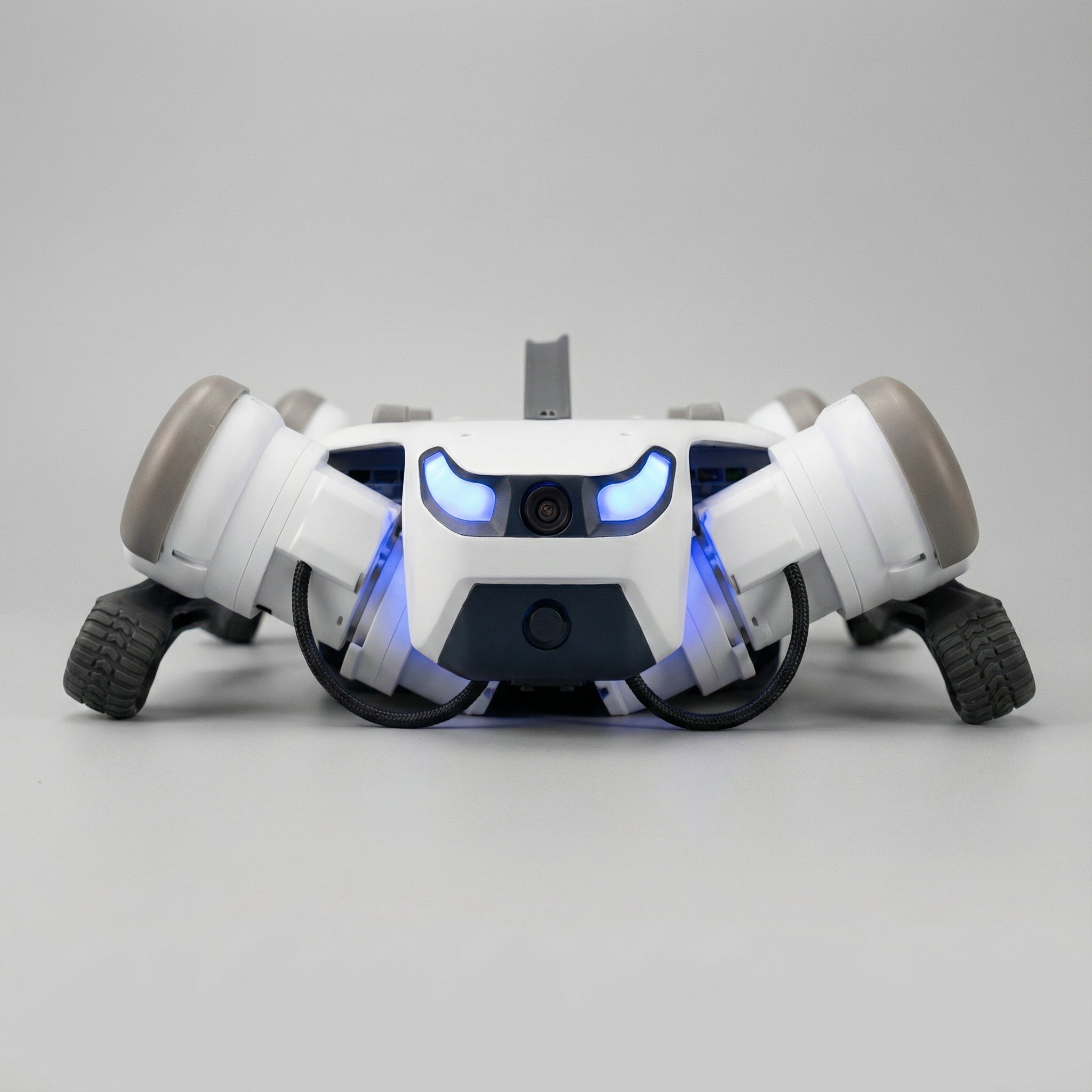 A DEEP Robotics Lite3 quadruped robot with glowing blue lights on its front, a central camera, and four wheeled legs, positioned on a light grey background. This advanced robot is designed for robotics research, education, and AI development, featuring modularity and autonomous navigation capabilities.
