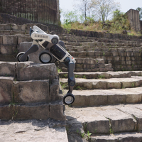 DEEP Robotics Lynx M20 Pro wheel-legged quadruped robot climbing stone stairs outdoors, demonstrating its advanced hybrid locomotion for all-terrain navigation and industrial inspection in challenging environments. Equipped with LiDAR and AI motion control, this rugged robot is designed for tasks like infrastructure inspection and emergency response.